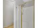 Close-up of stand-up shower stall with gold trim and hardware at 9665 E Nido Ave, Mesa, AZ 85209