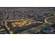 Night aerial view showcasing the community park, ponds, and interconnected roads of this vibrant neighborhood at 9906 E Wavelength Ave, Mesa, AZ 85212
