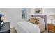 Bedroom with neutral walls and carpet, features a window and comfortable bed with plenty of pillows at 9906 E Wavelength Ave, Mesa, AZ 85212