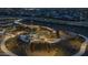 Aerial night view of a lively community park featuring playgrounds, picnic areas, and walking paths for residents to enjoy at 9906 E Wavelength Ave, Mesa, AZ 85212