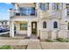 Charming two-story home featuring a balcony, arched windows, and a well-maintained front yard with a white picket fence at 9906 E Wavelength Ave, Mesa, AZ 85212