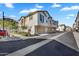 Exterior view of modern townhomes with two-car garages, landscaping, and a clean street at 9906 E Wavelength Ave, Mesa, AZ 85212