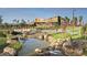 Stunning exterior view featuring modern architecture, a beautiful pond, and lush green landscaping in a vibrant community at 9906 E Wavelength Ave, Mesa, AZ 85212