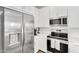 Close-up of a bright kitchen featuring stainless steel appliances and white cabinets at 9906 E Wavelength Ave, Mesa, AZ 85212