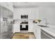 Well-lit modern kitchen boasts white cabinets, stainless steel appliances, and a stylish faucet at 9906 E Wavelength Ave, Mesa, AZ 85212