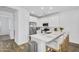 Bright, white kitchen featuring stainless steel appliances and a breakfast bar with seating at 9906 E Wavelength Ave, Mesa, AZ 85212