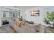 Bright living room featuring stylish sectional sofa, modern decor, and sliding glass doors to a balcony at 9906 E Wavelength Ave, Mesa, AZ 85212