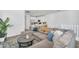 Open-concept living room with sectional sofa flowing into a modern kitchen with bar seating at 9906 E Wavelength Ave, Mesa, AZ 85212
