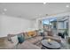 Spacious living room with sectional sofa, large windows, and view of the neighborhood at 9906 E Wavelength Ave, Mesa, AZ 85212