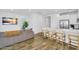 Open-concept living space with white cabinetry, a kitchen island, hardwood floors and comfortable seating at 9906 E Wavelength Ave, Mesa, AZ 85212