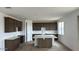 Contemporary kitchen featuring a center island, dark wood cabinetry, and modern countertops at 15146 W Gray Fox Trailer, Surprise, AZ 85387