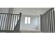 A staircase with dark railings leads to an upstairs living area with natural light at 15146 W Gray Fox Trailer, Surprise, AZ 85387