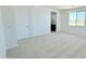 Light-filled bedroom with soft carpet, a bathroom access door, and an open window providing an outside view at 15146 W Gray Fox Trl, Surprise, AZ 85387