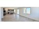 Open-concept living space with wood-look tile flooring, big windows, and sliding glass doors to the backyard at 15146 W Gray Fox Trl, Surprise, AZ 85387