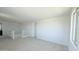 Spacious loft area with soft carpet flooring and access to an upstairs hallway and an outside view at 15146 W Gray Fox Trl, Surprise, AZ 85387