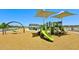 Community playground with slides, swings, and sun shades creating a fun outdoor space at 15146 W Gray Fox Trl, Surprise, AZ 85387
