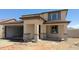 Two story home with a two car garage and desert landscaping at 15151 W Gray Fox Trl, Surprise, AZ 85387