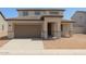Charming two-story home featuring a well-manicured lawn and a cozy front porch at 15151 W Gray Fox Trl, Surprise, AZ 85387
