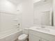 Bright bathroom featuring a tub-shower combo and single sink vanity at 16015 W Desert Hollow Dr, Surprise, AZ 85387
