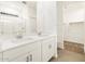 Bright bathroom features dual sinks, tile flooring, a large mirror, and a glass shower at 16015 W Desert Hollow Dr, Surprise, AZ 85387