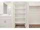 Bathroom view showcasing a vanity and built-in shelving in the closet at 16015 W Desert Hollow Dr, Surprise, AZ 85387