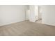 Neutral carpeted bedroom with access to the bathroom and closet at 16015 W Desert Hollow Dr, Surprise, AZ 85387
