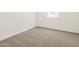 Bright bedroom features neutral carpet and fresh white paint at 16015 W Desert Hollow Dr, Surprise, AZ 85387