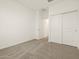 Bright bedroom features neutral carpet, closet, and fresh white paint at 16015 W Desert Hollow Dr, Surprise, AZ 85387