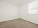 Bedroom with neutral carpet and a window with blinds at 16015 W Desert Hollow Dr, Surprise, AZ 85387