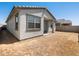 Exterior side view of new build home with backyard and hardscape at 16015 W Desert Hollow Dr, Surprise, AZ 85387