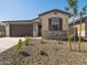 Inviting single-story home with a two-car garage featuring low-maintenance desert landscaping at 16015 W Desert Hollow Dr, Surprise, AZ 85387