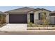 Charming single-story home with a two-car garage and well-maintained desert landscaping at 16015 W Desert Hollow Dr, Surprise, AZ 85387