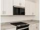Close-up of a modern kitchen showcasing granite countertops and stainless steel appliances at 16015 W Desert Hollow Dr, Surprise, AZ 85387