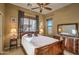 Comfortable bedroom features a ceiling fan, large windows, and stylish decor that enhances the room's warmth at 6833 N 71St Dr, Glendale, AZ 85303