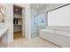 Luxurious bathroom with a freestanding tub, walk-in shower, and access to a walk-in closet at 100 W Northern Ave # 6, Phoenix, AZ 85021