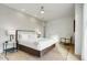 Modern bedroom featuring a ceiling fan, accent chair, and a comfortable king-size bed at 100 W Northern Ave # 6, Phoenix, AZ 85021