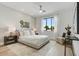 Bright bedroom with a comfortable bed, stylish decor, and ample natural light from a large window at 100 W Northern Ave # 6, Phoenix, AZ 85021