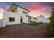 Modern home exterior with manicured landscaping, clean lines, and stunning sunset views at 100 W Northern Ave # 6, Phoenix, AZ 85021