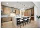 Gourmet kitchen featuring a large island with bar seating, modern appliances, and sleek cabinetry at 100 W Northern Ave # 6, Phoenix, AZ 85021