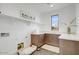 Bright laundry room boasts a sink, cabinets, open shelving and a cozy pet area at 100 W Northern Ave # 6, Phoenix, AZ 85021