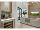 Living room adjacent to wet bar featuring a large sliding glass door to outdoor patio and comfortable seating at 100 W Northern Ave # 6, Phoenix, AZ 85021