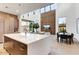 Open-concept living space showcasing the kitchen, living and dining areas with hardwood flooring at 100 W Northern Ave # 6, Phoenix, AZ 85021
