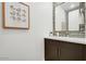 Modern powder room featuring a stylish mirror, vanity, and gray tile backsplash at 100 W Northern Ave # 6, Phoenix, AZ 85021