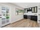 Chic bar area with dark cabinetry, a wine cooler, and a window overlooking the backyard, great for hosting at 1012 E Magdalena Dr, Tempe, AZ 85283