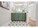 Bathroom showcasing olive green vanity with star-patterned tile floors and modern mirror at 1012 E Magdalena Dr, Tempe, AZ 85283