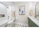 Stylishly renovated bathroom with star-patterned floors, green vanity, and tiled shower for a spa-like experience at 1012 E Magdalena Dr, Tempe, AZ 85283