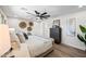 Bright bedroom features a ceiling fan, wood floors, textured wall art, and natural light at 1012 E Magdalena Dr, Tempe, AZ 85283