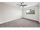 The bedroom includes carpet floors, a ceiling fan, and a large window at 1012 E Magdalena Dr, Tempe, AZ 85283