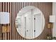 Hallway with wood accent wall, gold sconce lights and mirrors at 1012 E Magdalena Dr, Tempe, AZ 85283