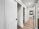 Hallway with wood floors and white sliding doors to bedrooms and bathrooms at 1012 E Magdalena Dr, Tempe, AZ 85283